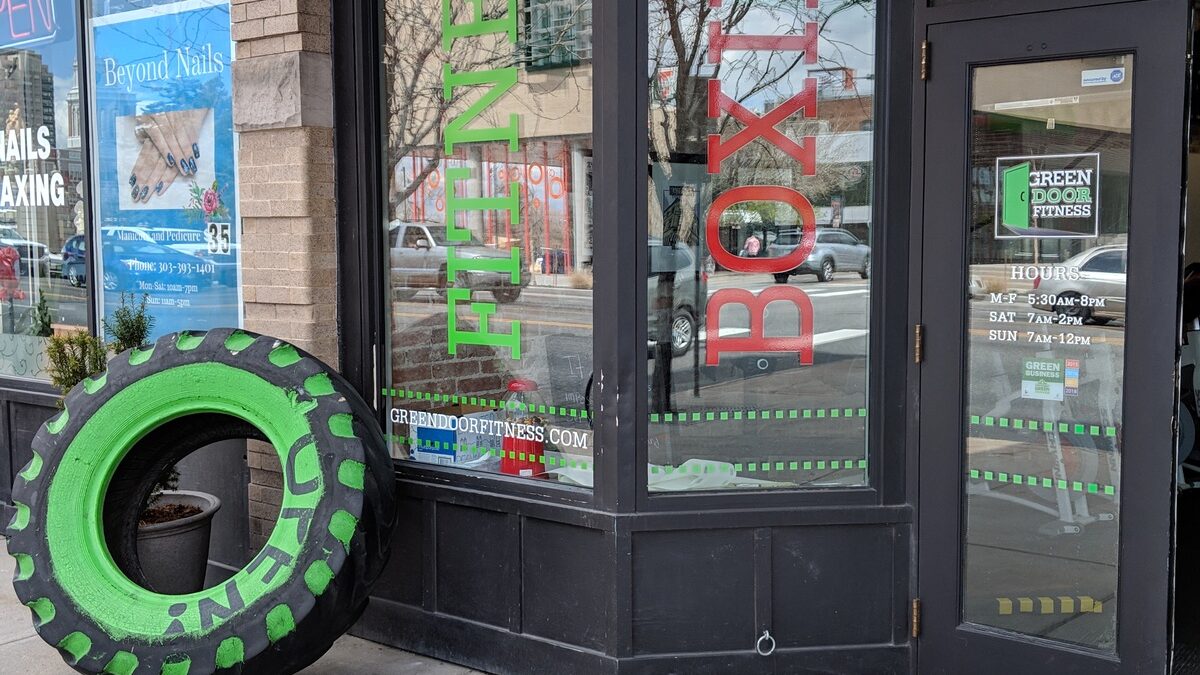 A green tire sitting in front of a store.